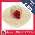 Wide brimmed straw hat with flower decoration